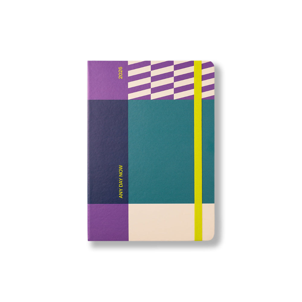 Colorful geometric-patterned notebook with 'Any Day Now' branding on a white background