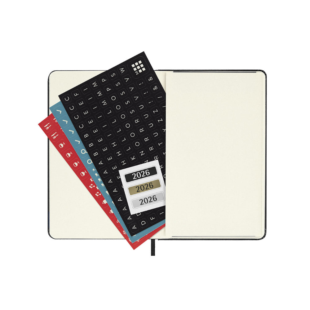 Open notebook with planner stickers featuring the year 2026 on a white background