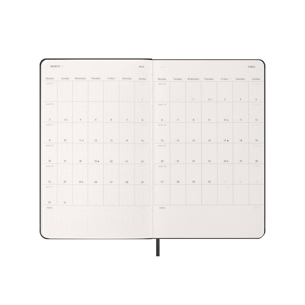 Calendar notebook open to a monthly view on a white background