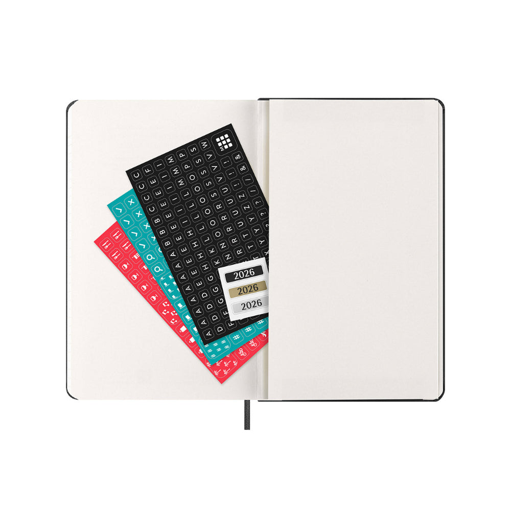 Open notebook with planner stickers on a white background