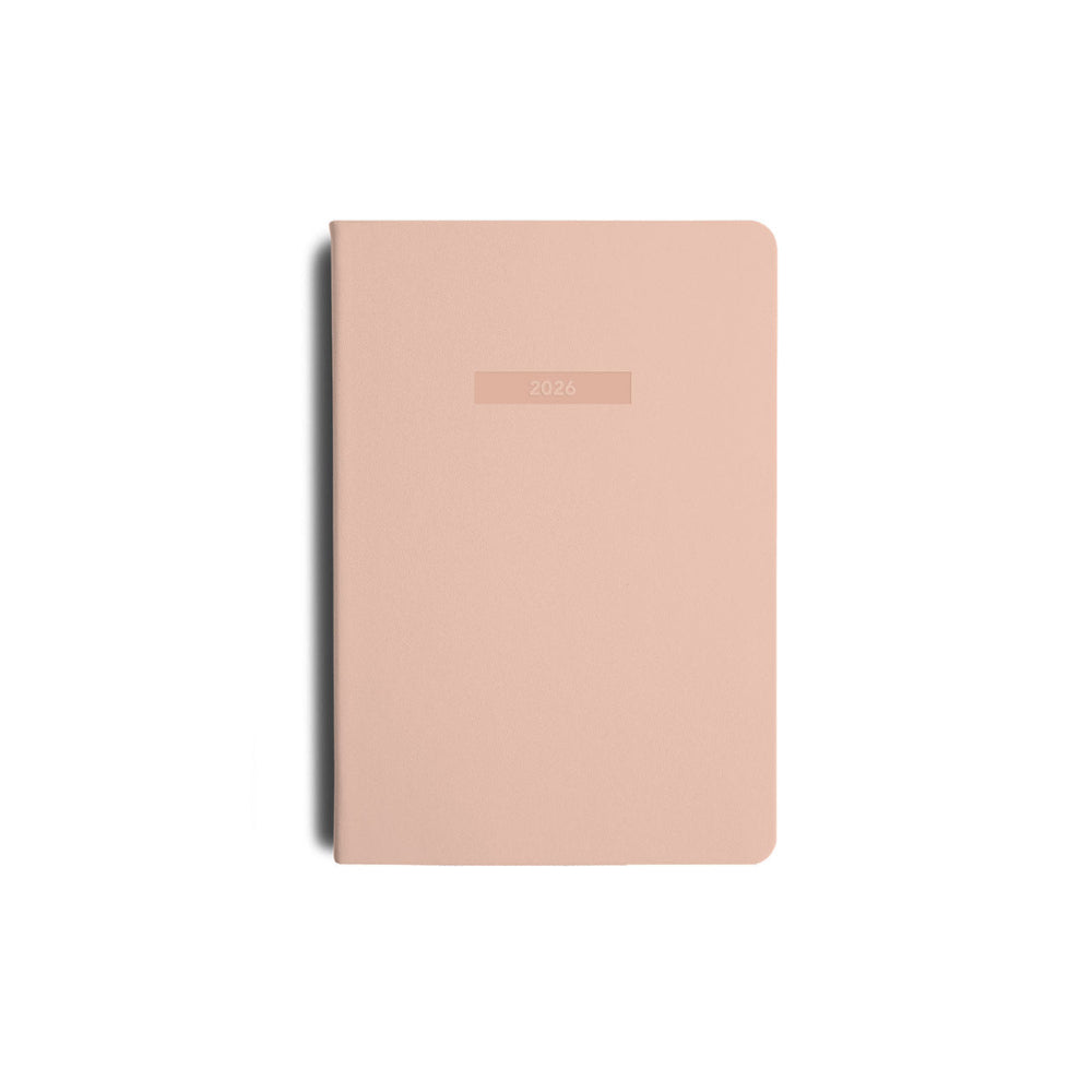 Pink notebook with "2026" embossed on a white background