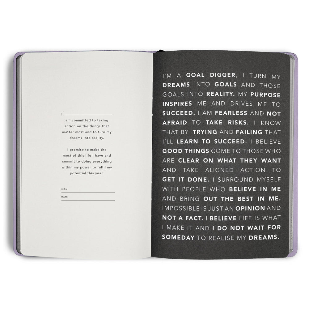 Open notebook with motivational text on a white background