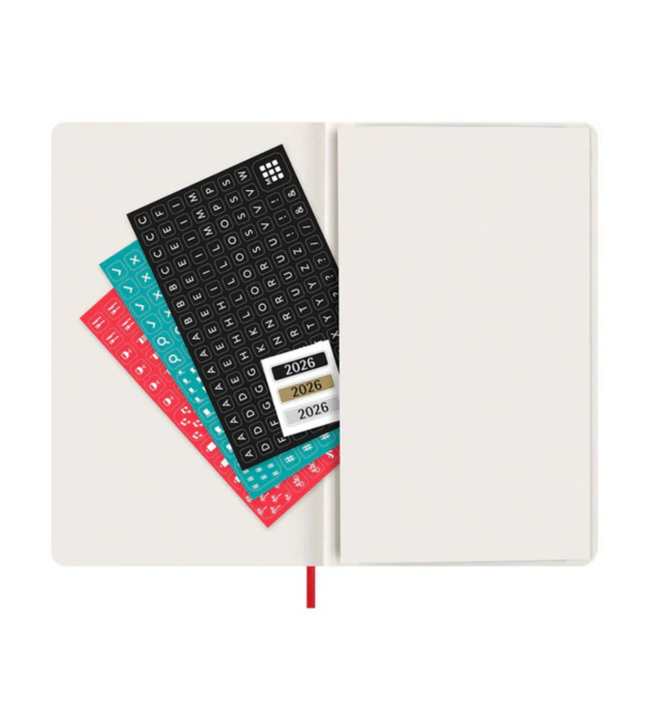 Open notebook with planner stickers featuring years 2026 on a white background